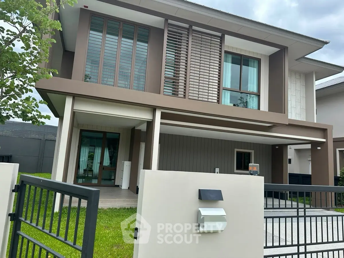 Modern two-story house with sleek design and spacious driveway in a serene neighborhood.