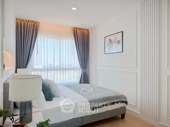 Bright and modern bedroom with elegant decor and large window view.