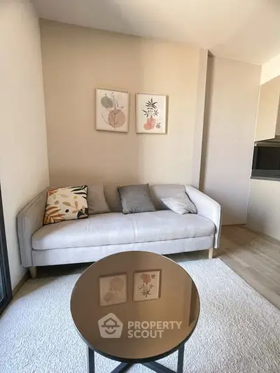 Cozy living room with modern sofa and stylish decor in a bright apartment.