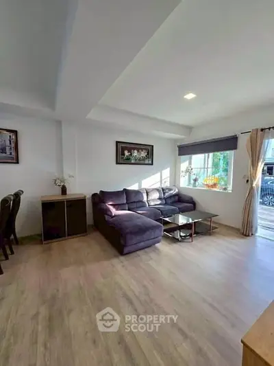 Spacious living room with modern decor and large windows for natural light.