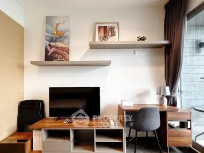 Modern study room with stylish desk, shelves, and TV setup in a contemporary apartment.