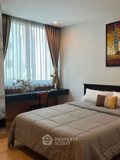 Cozy bedroom with large window and modern decor in a stylish apartment.