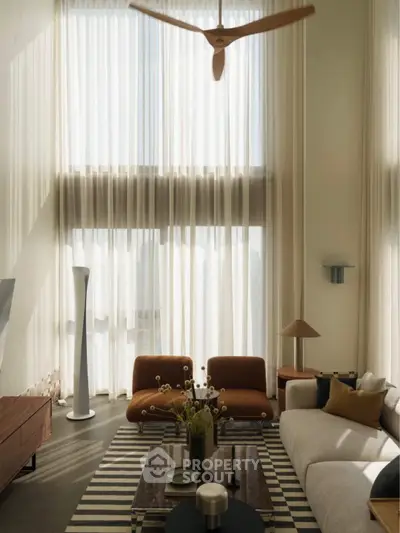 Luxurious living room with high ceilings, modern furniture, and elegant decor in a sunlit space.