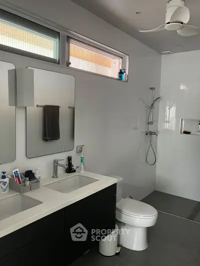 Modern bathroom with dual sinks and sleek shower design