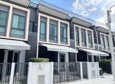 Modern townhouse exterior with sleek design and gated entrance, perfect for urban living.