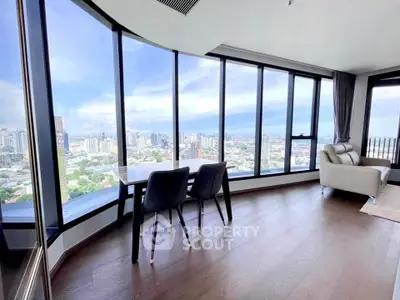 Stunning high-rise living room with panoramic city views and modern furnishings.