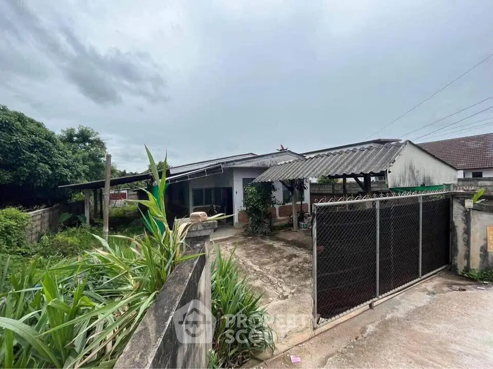 Charming single-story home with spacious yard and gated entrance, perfect for family living.