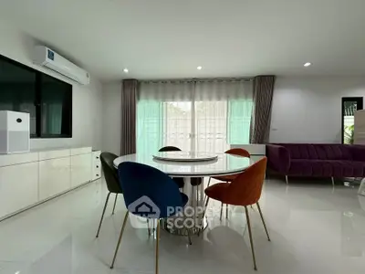Modern living room with colorful chairs and sleek furniture, perfect for stylish urban living.