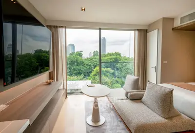 Luxurious living room with modern decor and stunning city view through large windows.