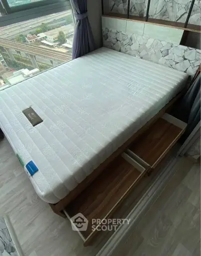 Modern bedroom with built-in storage bed and city view window