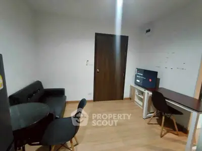 Modern living room with sleek furniture and wooden flooring, perfect for cozy gatherings.