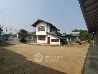 Charming two-story house with spacious yard and traditional architecture.