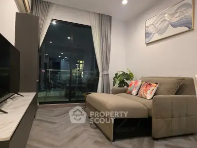 Modern living room with stylish decor and city view from balcony.