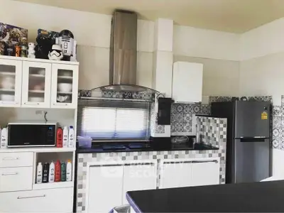 Modern kitchen with sleek appliances and stylish backsplash design.