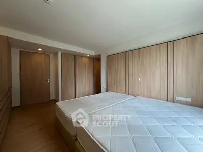Spacious bedroom with twin beds and ample closet space, perfect for modern living.