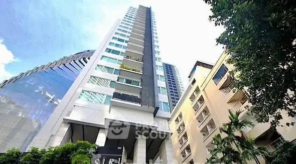 Stunning high-rise building exterior with modern architecture and lush greenery.