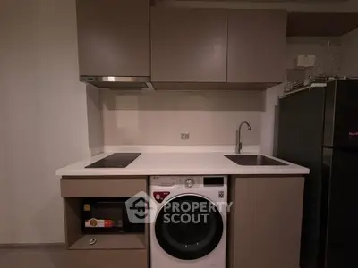 Compact modern kitchen with integrated appliances and sleek cabinetry