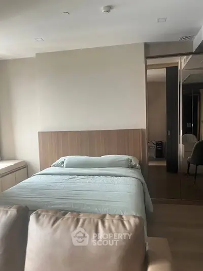Modern bedroom with sleek design and cozy ambiance, featuring a comfortable bed and stylish decor.
