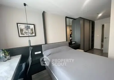Modern bedroom with sleek design and ample storage in a stylish apartment.