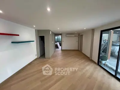 Spacious modern living room with wooden flooring and large windows
