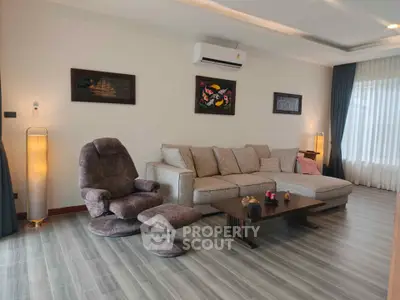 Spacious living room with modern decor and comfortable seating in a stylish apartment.