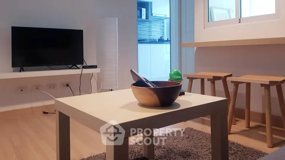 Modern living room with stylish furniture and open kitchen view.