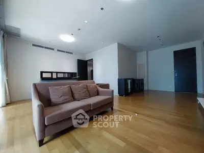 Spacious modern living room with wooden flooring and stylish sofa