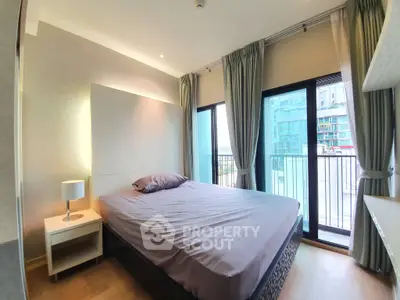 Modern bedroom with large windows and balcony in urban apartment