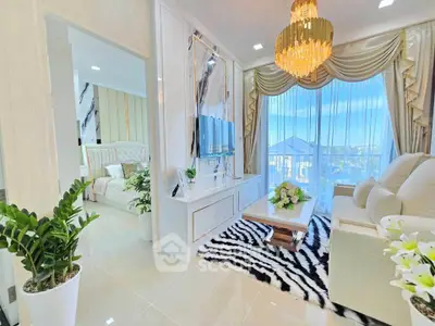Luxurious living room with elegant decor and a view into a stylish bedroom, featuring a chandelier and zebra-patterned rug.