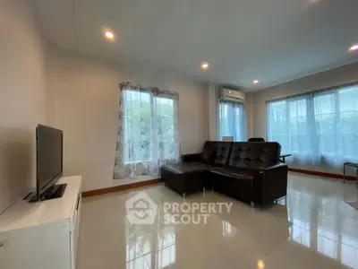 Spacious living room with modern furniture and large windows for natural light.