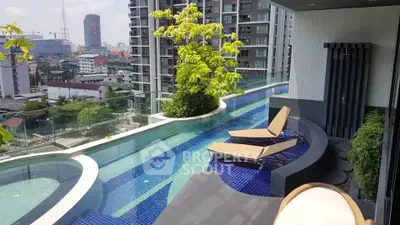 Luxurious rooftop pool with stunning city views and modern lounge chairs in a high-rise building.