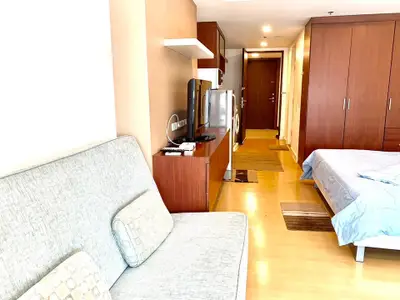 Spacious studio apartment with modern furnishings and wooden flooring