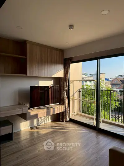Modern living room with wooden flooring and balcony view