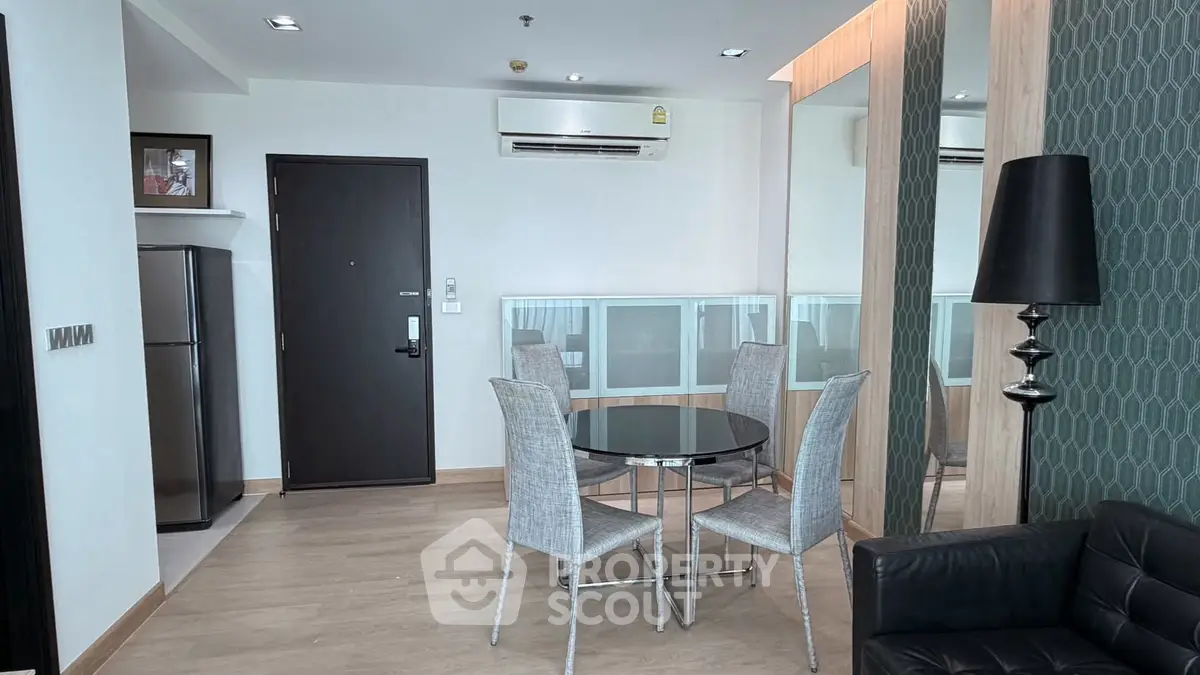 Modern living room with dining area, sleek furniture, and stylish decor in a contemporary apartment.