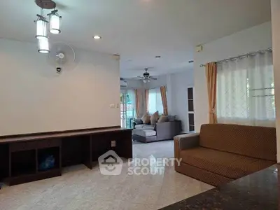 Spacious living room with modern lighting and comfortable seating