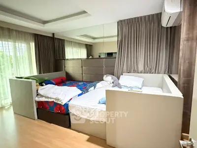 Spacious bedroom with modern design and large windows for natural light