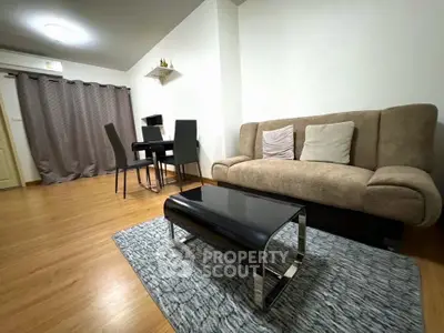 Modern living room with stylish furniture and wooden flooring, perfect for cozy gatherings.