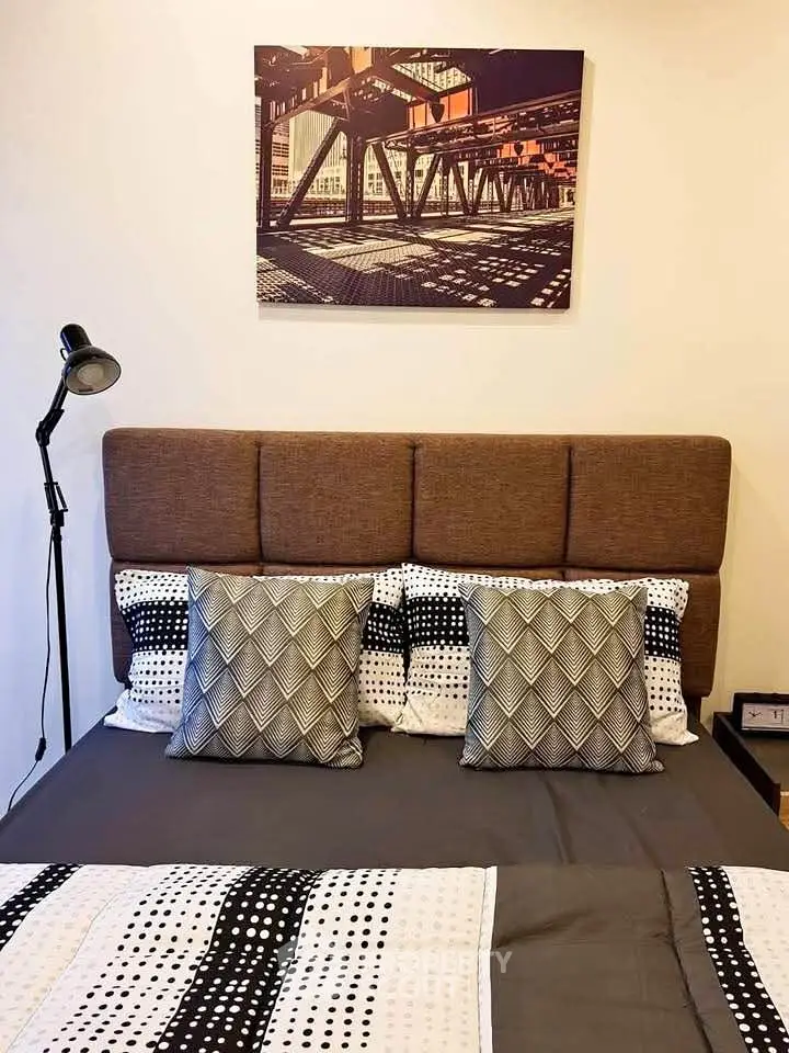 Cozy bedroom with stylish decor and modern artwork, perfect for relaxation and comfort.