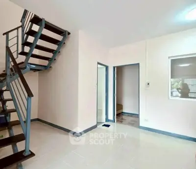 Modern interior with stylish staircase and open layout, perfect for contemporary living.