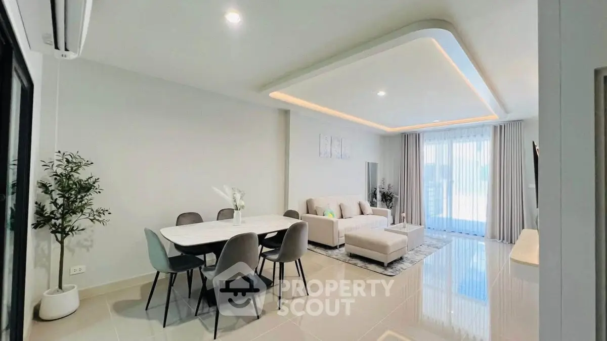 Spacious modern living room with elegant dining area and natural light