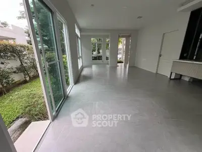 Spacious modern living room with large windows and garden view