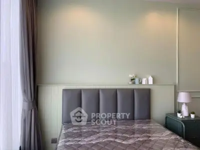 Modern bedroom with elegant decor and soft lighting, featuring a stylish bed and side table.