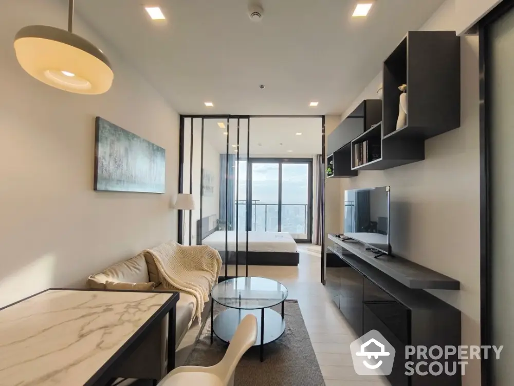 Modern open-concept living room with stylish decor and expansive city view balcony.