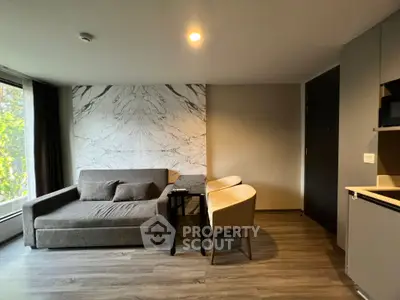 Modern living room with stylish marble accent wall and cozy seating area.