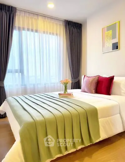 Elegant bedroom with modern decor and large window for natural light