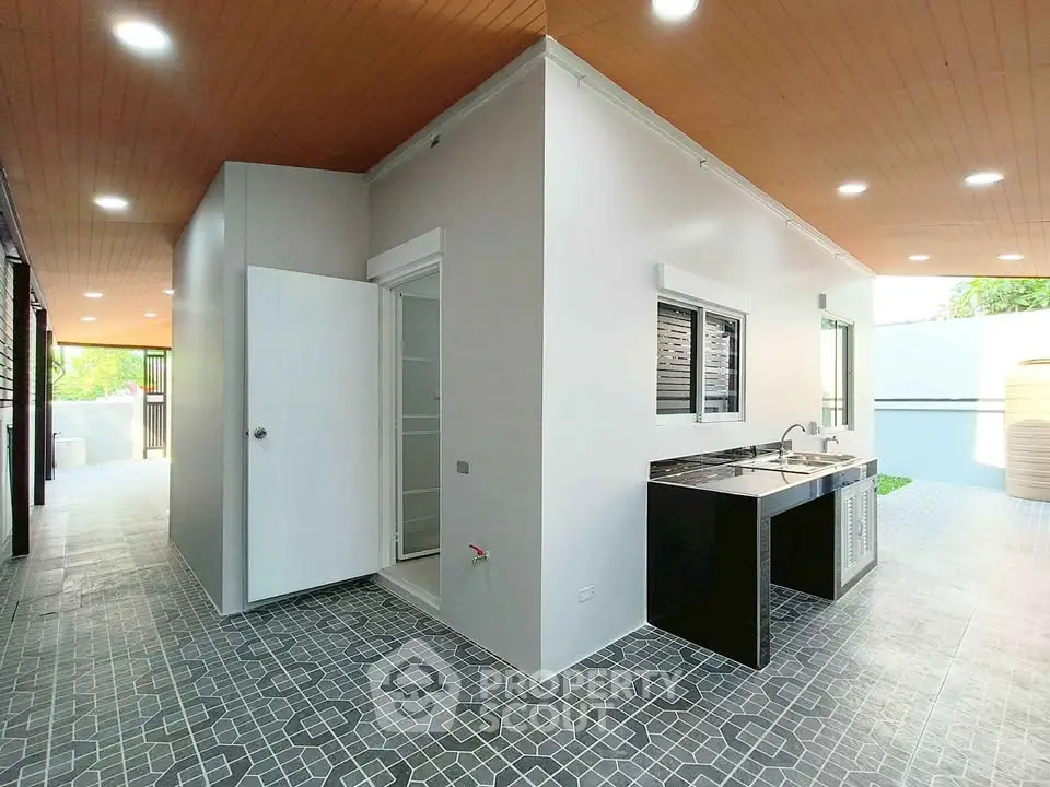 Modern exterior with sleek design and outdoor kitchen area