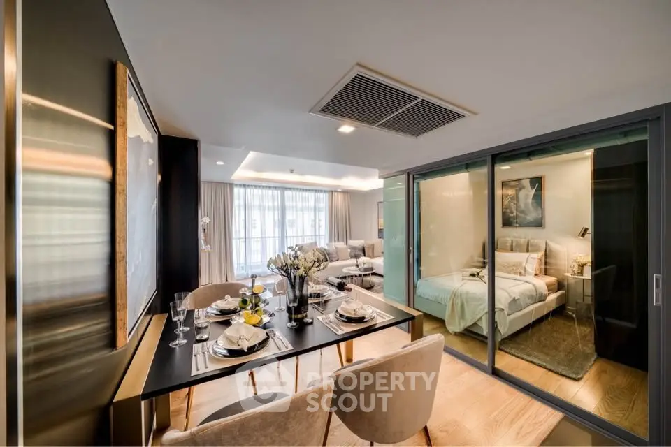 Luxurious open-plan living and dining area with elegant decor and cozy bedroom view.