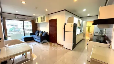 Spacious open-plan living room with modern kitchen and balcony view