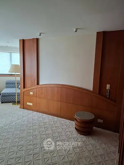 Spacious living room with elegant wood paneling and cozy seating area