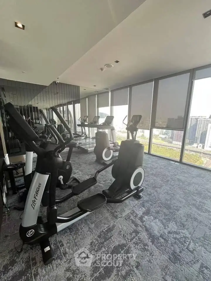 Modern gym with city view and state-of-the-art fitness equipment